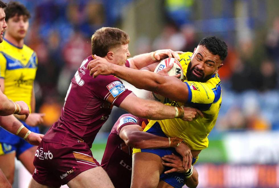 Warrington Wolves' Zane Musgrove (right) tackled by Huddersfield Giants' Zac Woolford during th ...