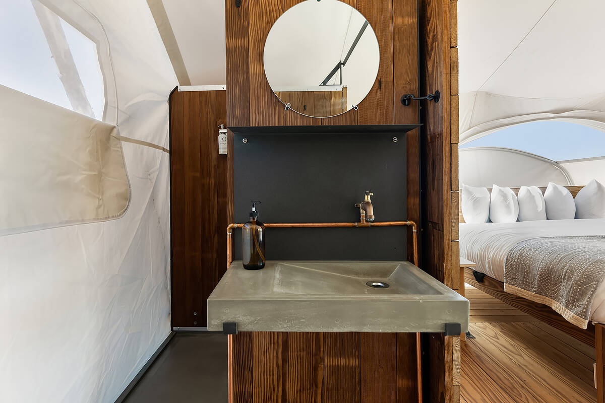 Each safari-inspired stargazing tent is equipped with plush bedding, upgraded linens, a private ...