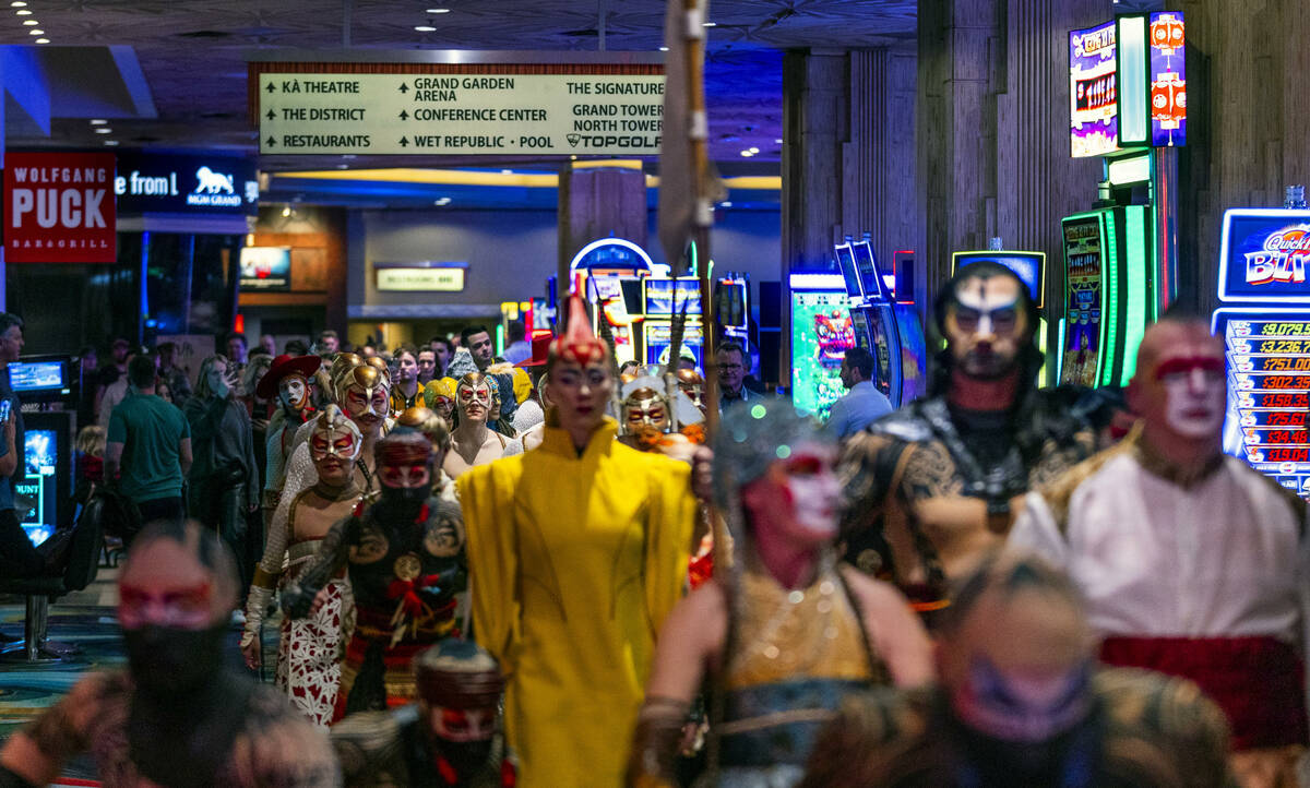 Performers with “Ka” parade through the MGM Grand during a celebration performance ...