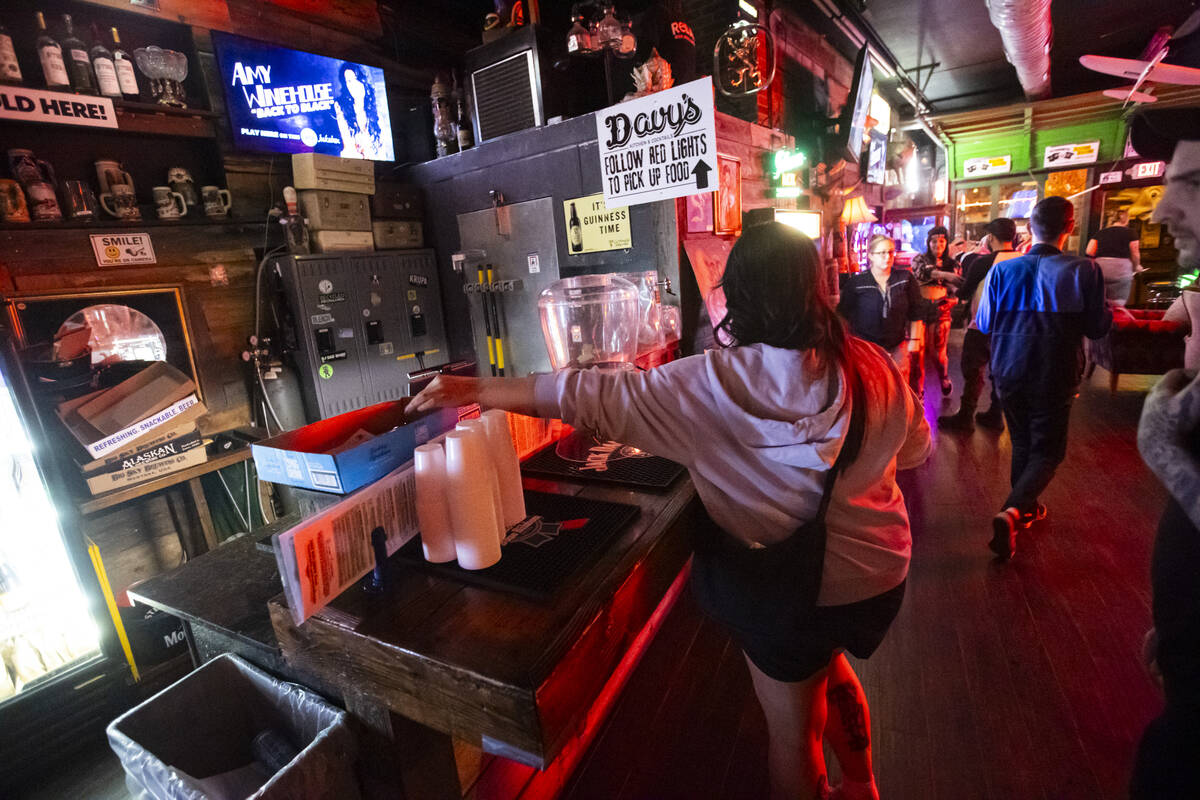 People drop off their answer sheets during trivia night at ReBAR on Monday, Feb. 24, 2025, in L ...