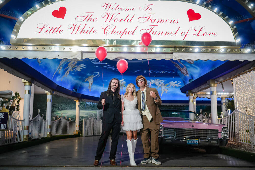 A disguised Coldplay singer Chris Martin delivers balloons to a couple having their wedding pho ...