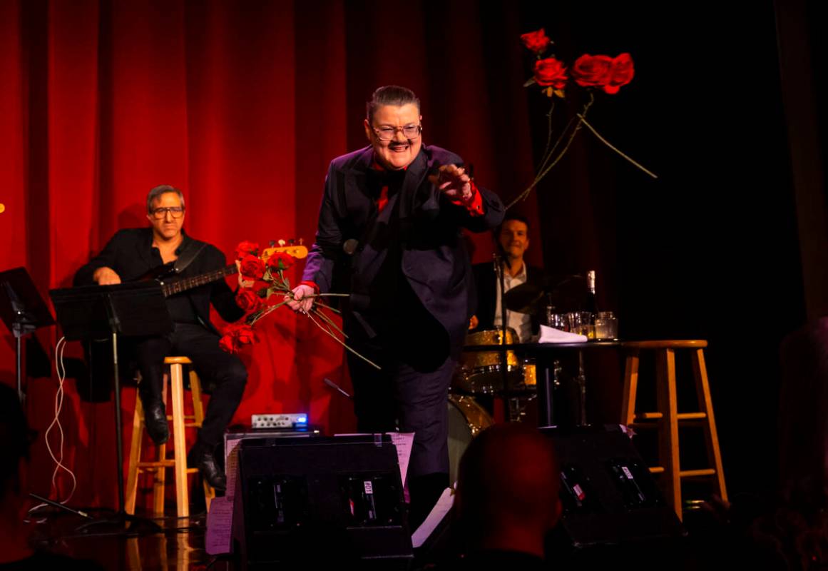 Comedian Murray Hill throws roses into the crowd at the end of his show at the Plaza Showroom o ...