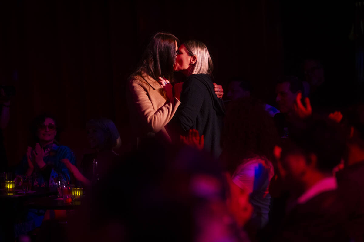 A couple kisses after being requested to by comedian Murray Hill at the Plaza Showroom in a sho ...