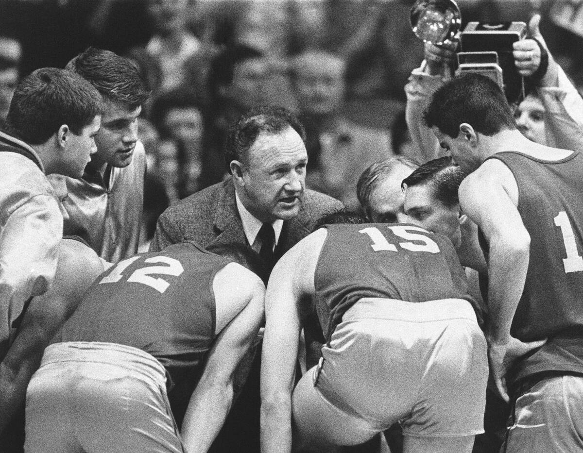 Actor Gene Hackman gives fictional Hickory High basketball players instructions during filming ...
