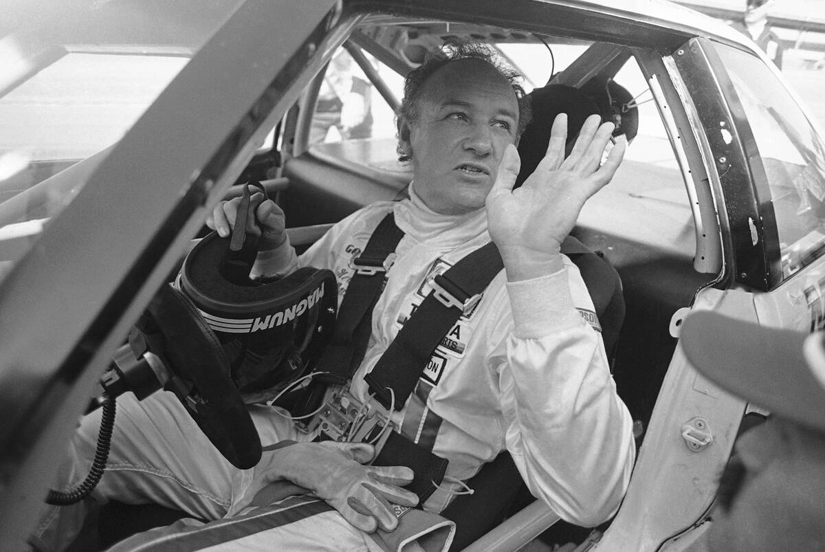 Actor Gene Hackman waves as he starts out for a practice run in his Toyota Celica, Feb. 5, 1983 ...