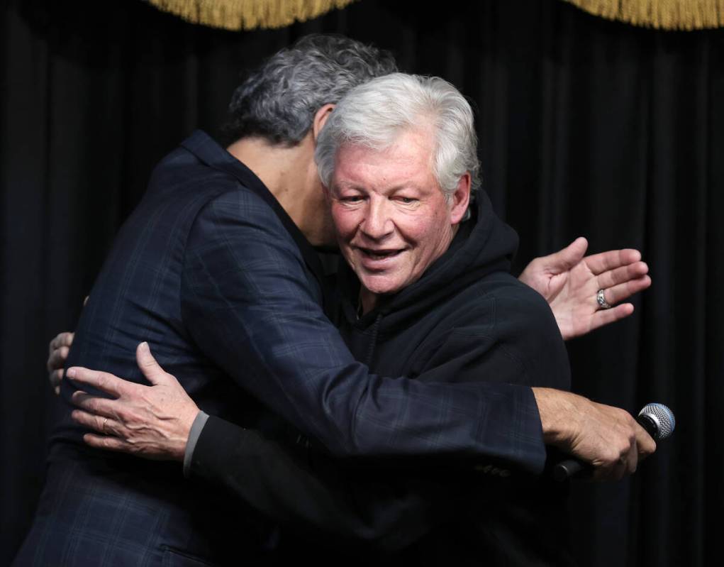 Brian McMullan of McMullan’s Irish Pub, right, hugs Brad Garrett before Garrett shaves t ...