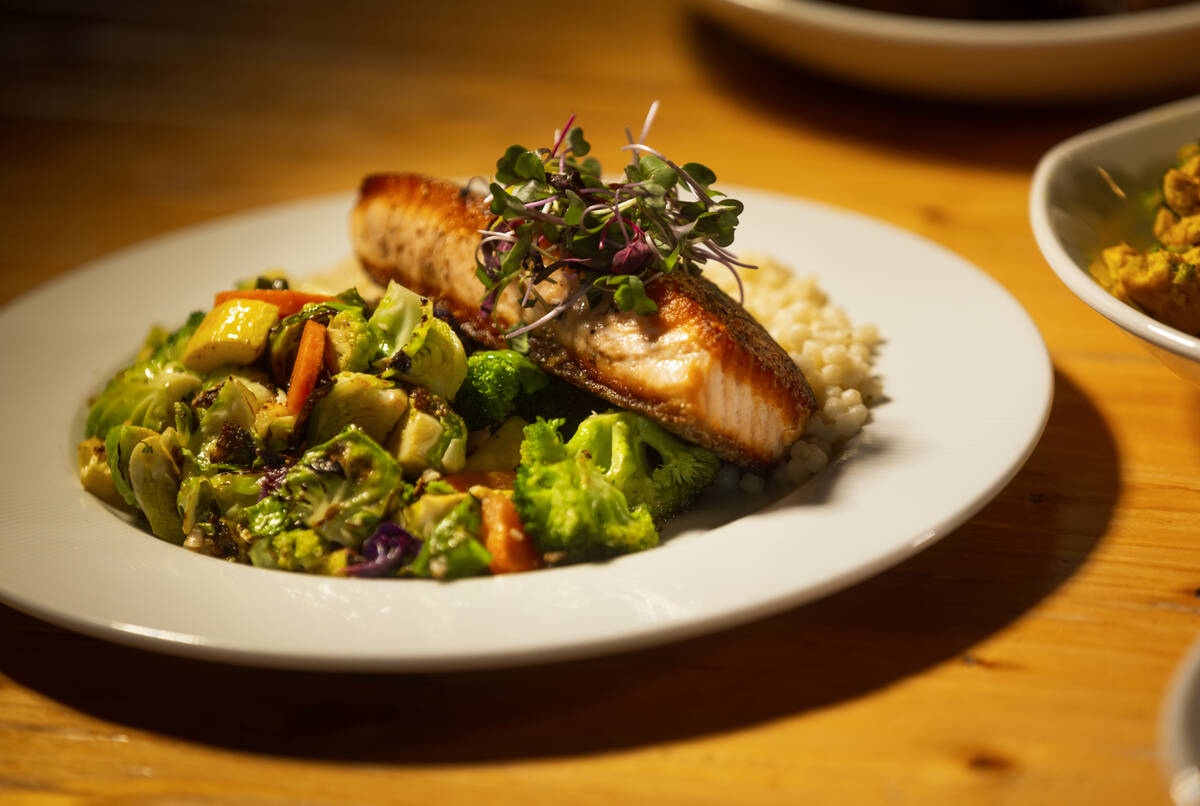 A salmon bowl with sautéed vegetables and couscous is seen at DW Bistro at The Gramercy on ...