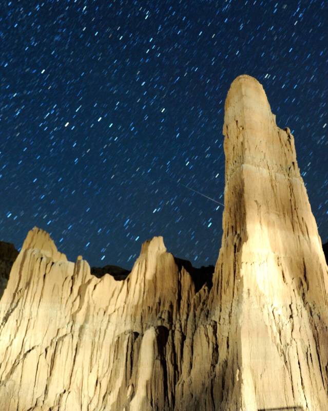 A Perseid meteor streaks by a cathedral-shaped spire early August 12, 2013 in Cathedral Gorge S ...