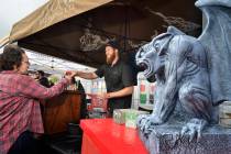 Adam Quinn hands a beer sample to a festivalgoer at the Stone Brewing company tent during the G ...