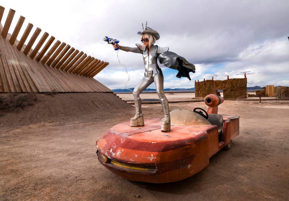A costumed Sarah Jane Woodall strikes a pose atop a sand cruiser at OutpostX, an otherworldly r ...