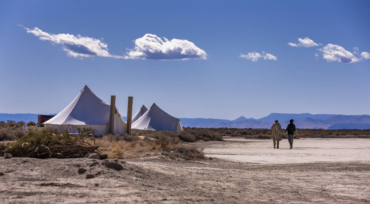 Guests walk across the player to their tent at Outpost X on Tuesday, Feb. 11, 2025 in Beryl, Ut ...