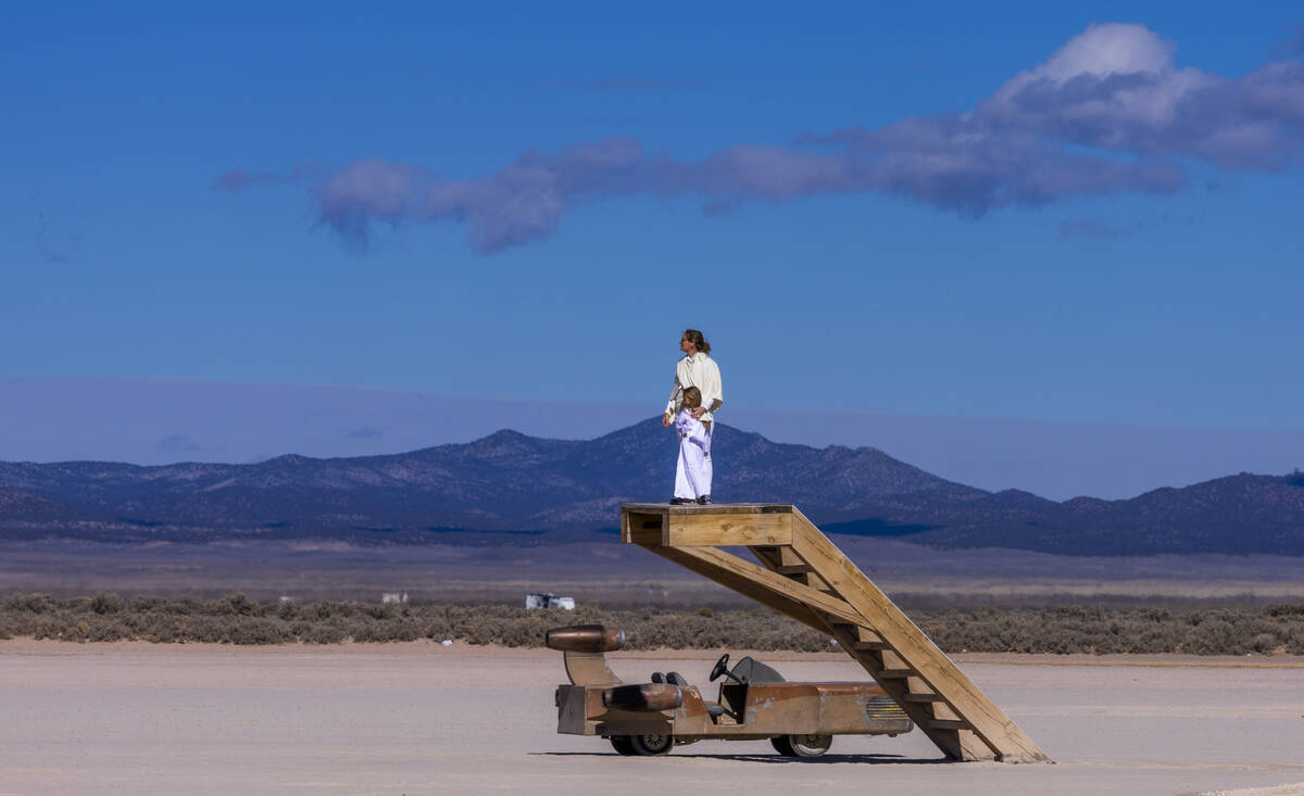 Melissa Ray and daughter Evie, 6, of Dallas look out above the playa with their Sand cruiser ne ...