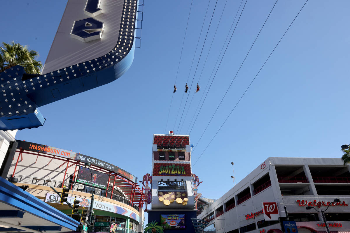 People ride the Super-Hero Zoom zoom line at SlotZilla at the Fremont Street Experience in down ...