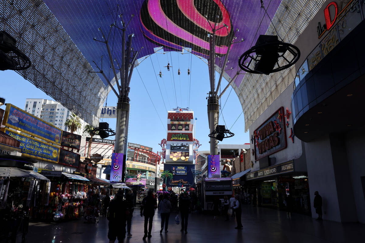 People ride the Super-Hero Zoom zoom line at SlotZilla at the Fremont Street Experience in down ...
