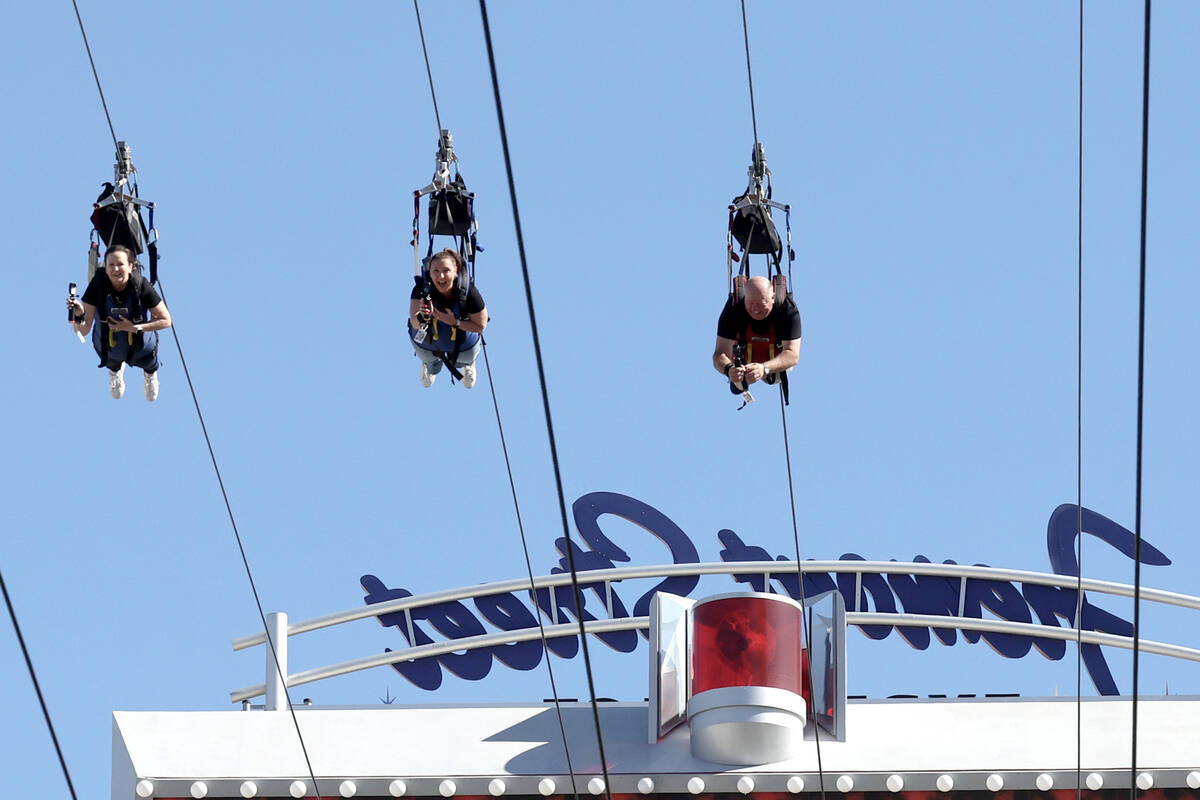 People ride the Super-Hero Zoom zoom line at SlotZilla at the Fremont Street Experience in down ...