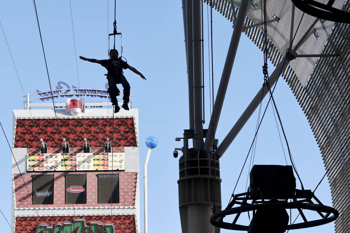 A person rides the Zip-Zilla zip line at SlotZilla at the Fremont Street Experience in downtown ...