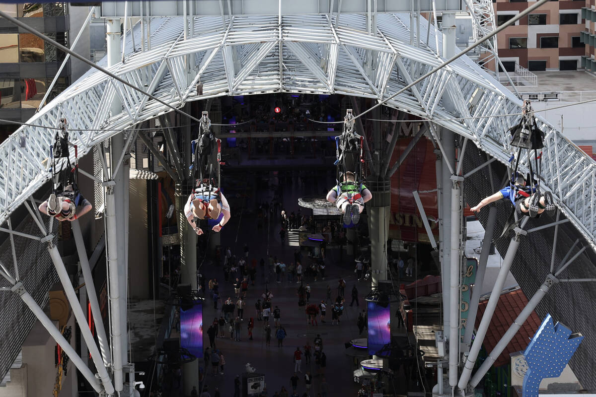 People ride the Super-Hero Zoom zoom line at SlotZilla at the Fremont Street Experience in down ...