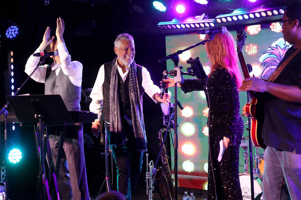 Kelly Clinton-Holmes hands the microphone to her husband Clint Holmes during the annual John Ka ...