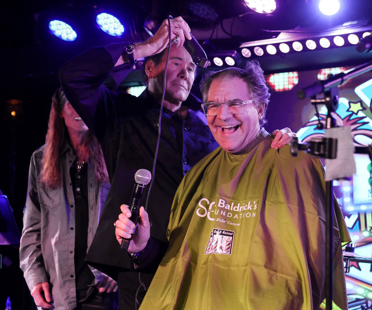 Las Vegas Review-Journal entertainment columnist John Katsilometes has his head shaved by Mr. L ...