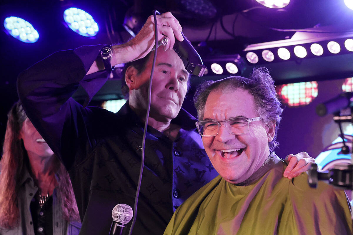 Las Vegas Review-Journal entertainment columnist John Katsilometes has his head shaved by Mr. L ...