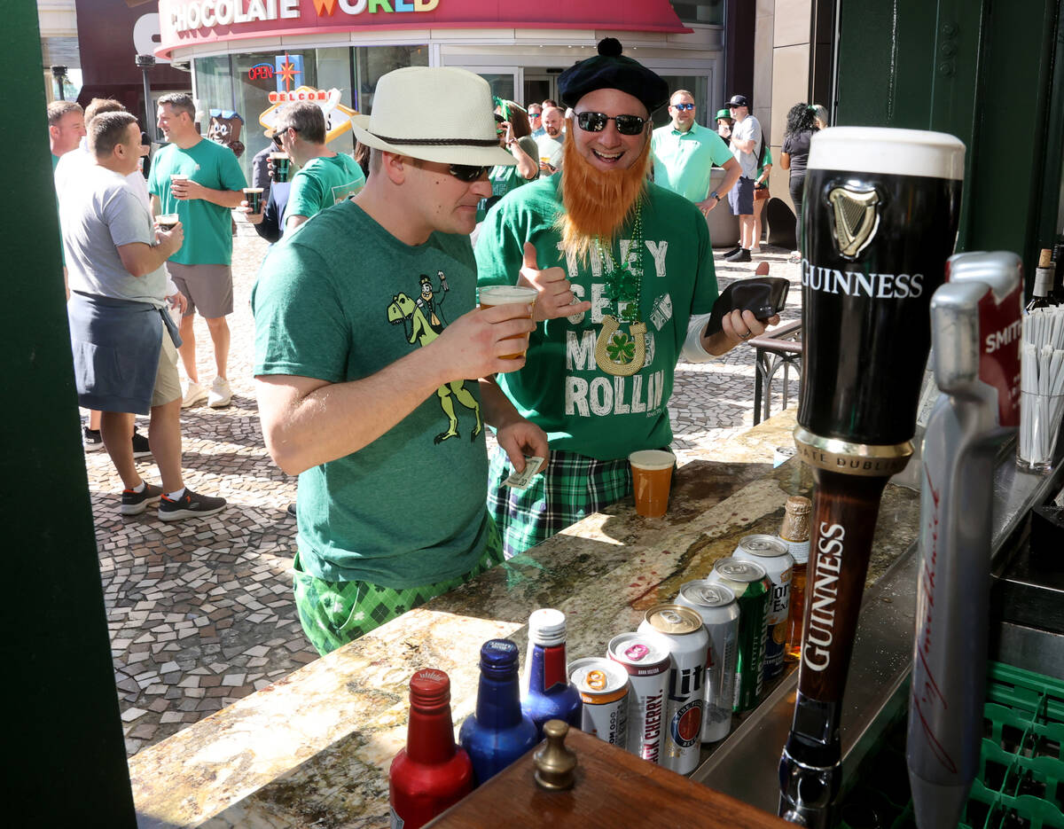 Cody Ablett, left, and his father Ford Ablett, both of Grand Rapids, Mich., celebrate St. Patri ...