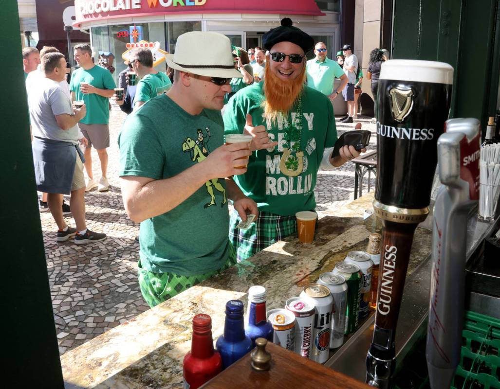 Cody Ablett, left, and his father Ford Ablett, both of Grand Rapids, Mich., celebrate St. Patri ...