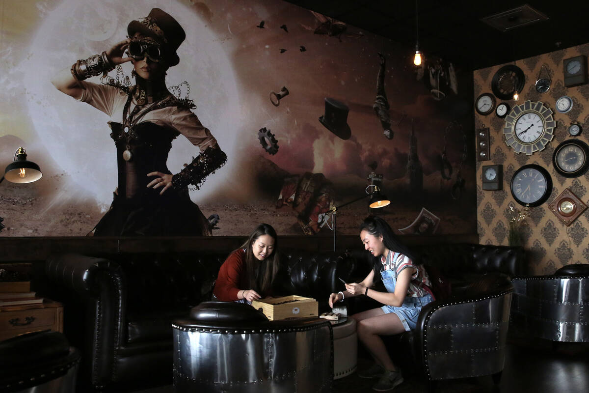 Stephanie Lo, left, and her sister Emily play games at Escapology, Tuesday, March. 26, 2019, in ...