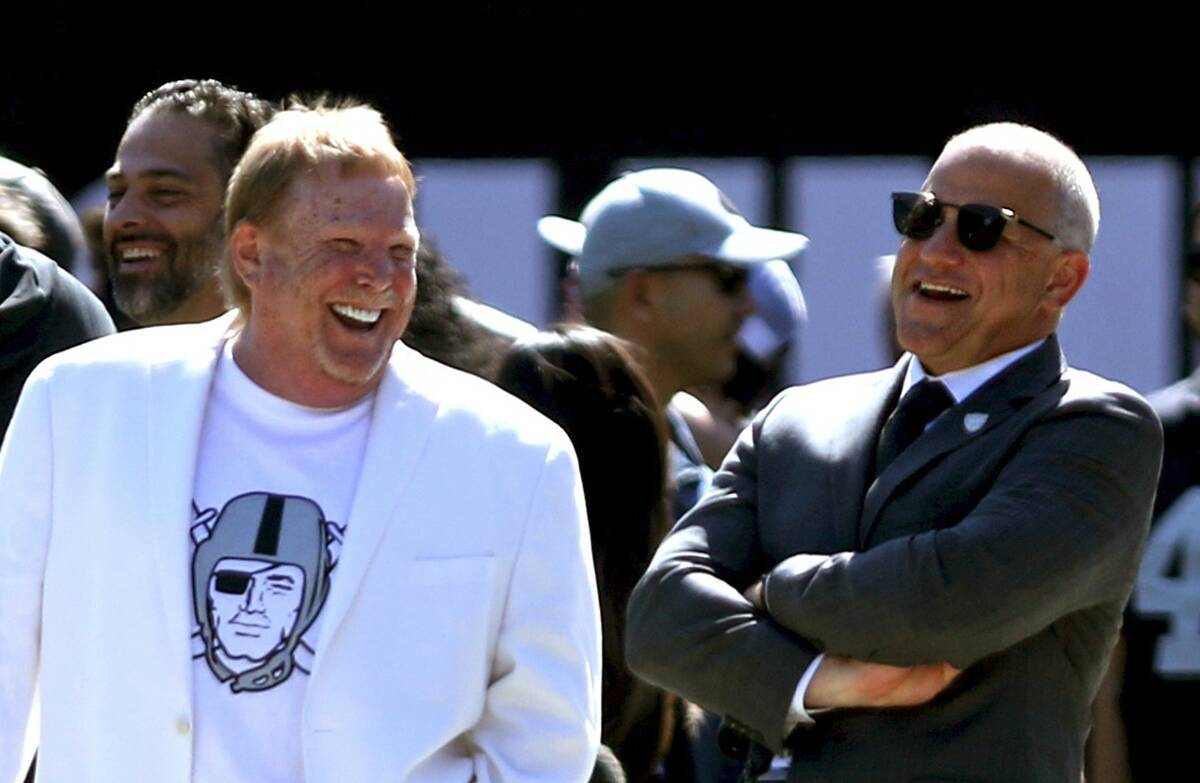 Raiders owner Mark Davis, left, and president Marc Badain share a laugh before an NFL game agai ...