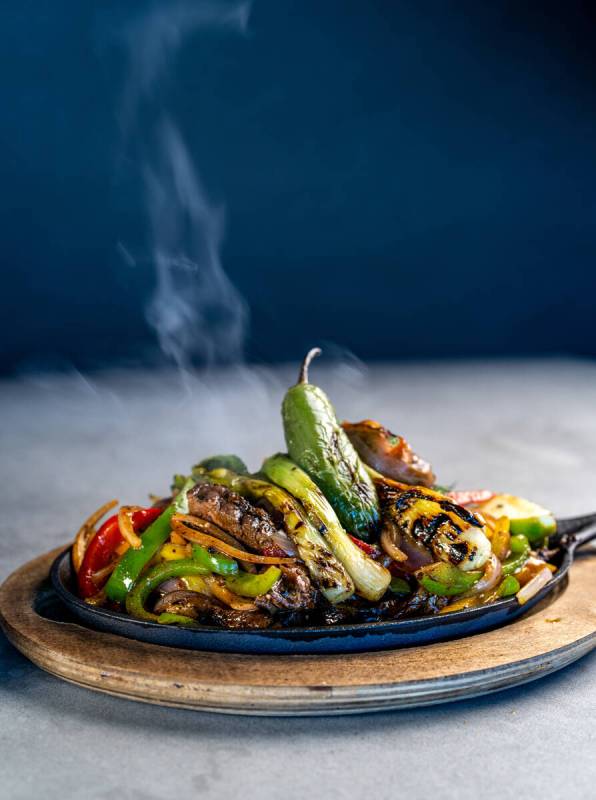 Sizzling fajitas from Patio, a poolside dining experience debuting April 4, 2025, at the M Reso ...