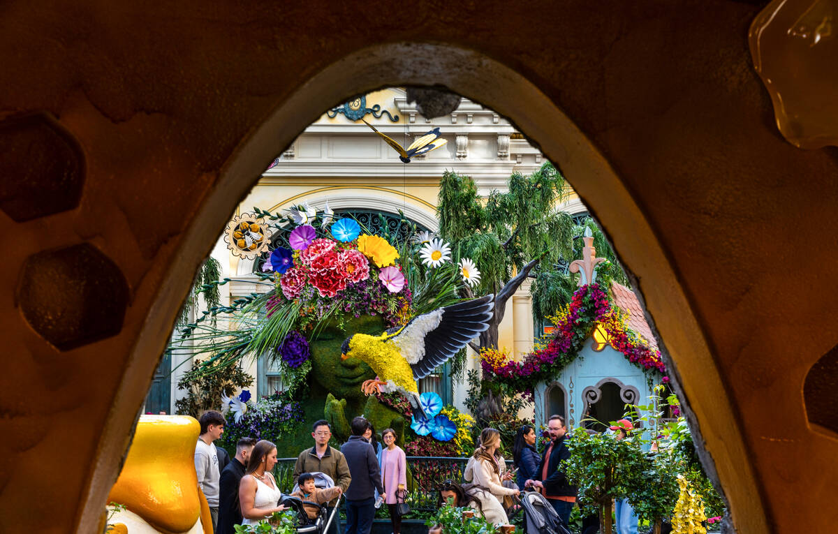 Visitors walk amongst a woman, birds and butterflies within the "The Birds and the B&#x201 ...