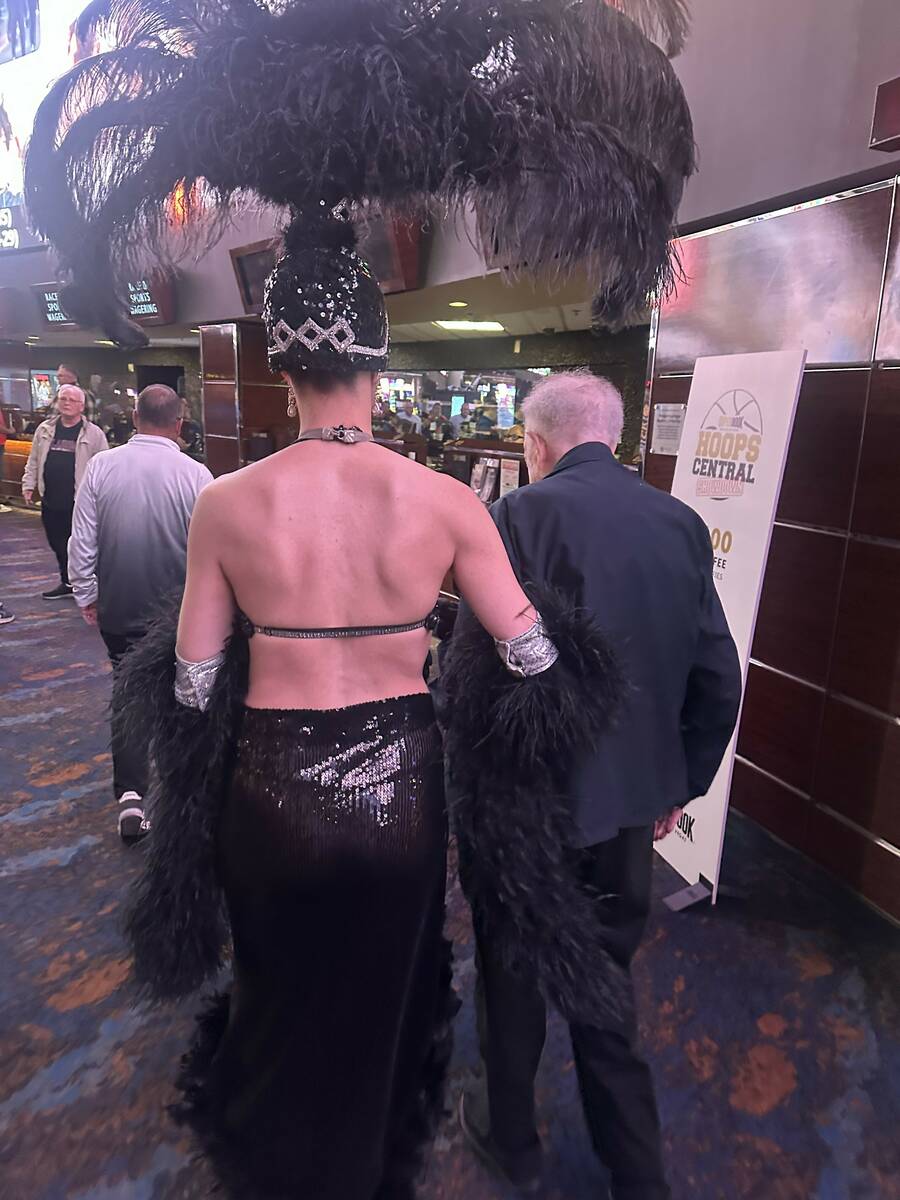 Former Las Vegas Mayor Oscar Goodman walks with showgirl Brit Dunn at Westgate SuperBook on Wed ...