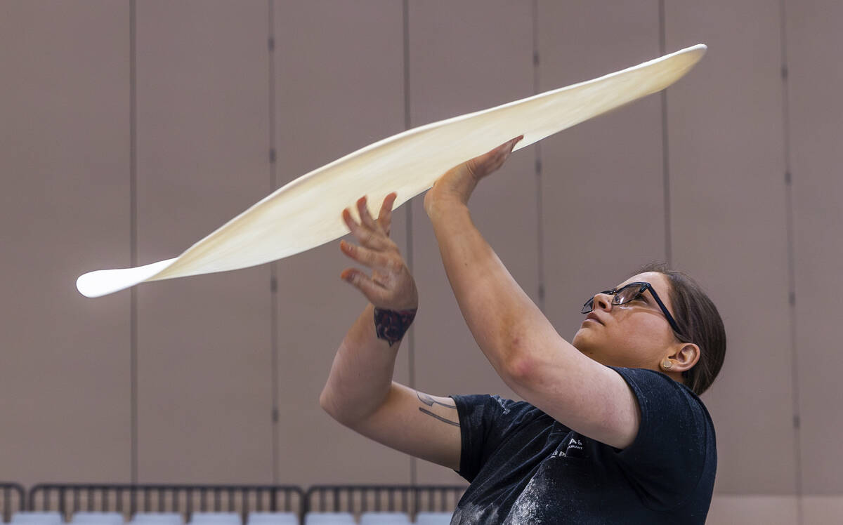 Competitor Tara Hattan with Andolini’s Pizzeria tosses her large pie dough during the Piz ...