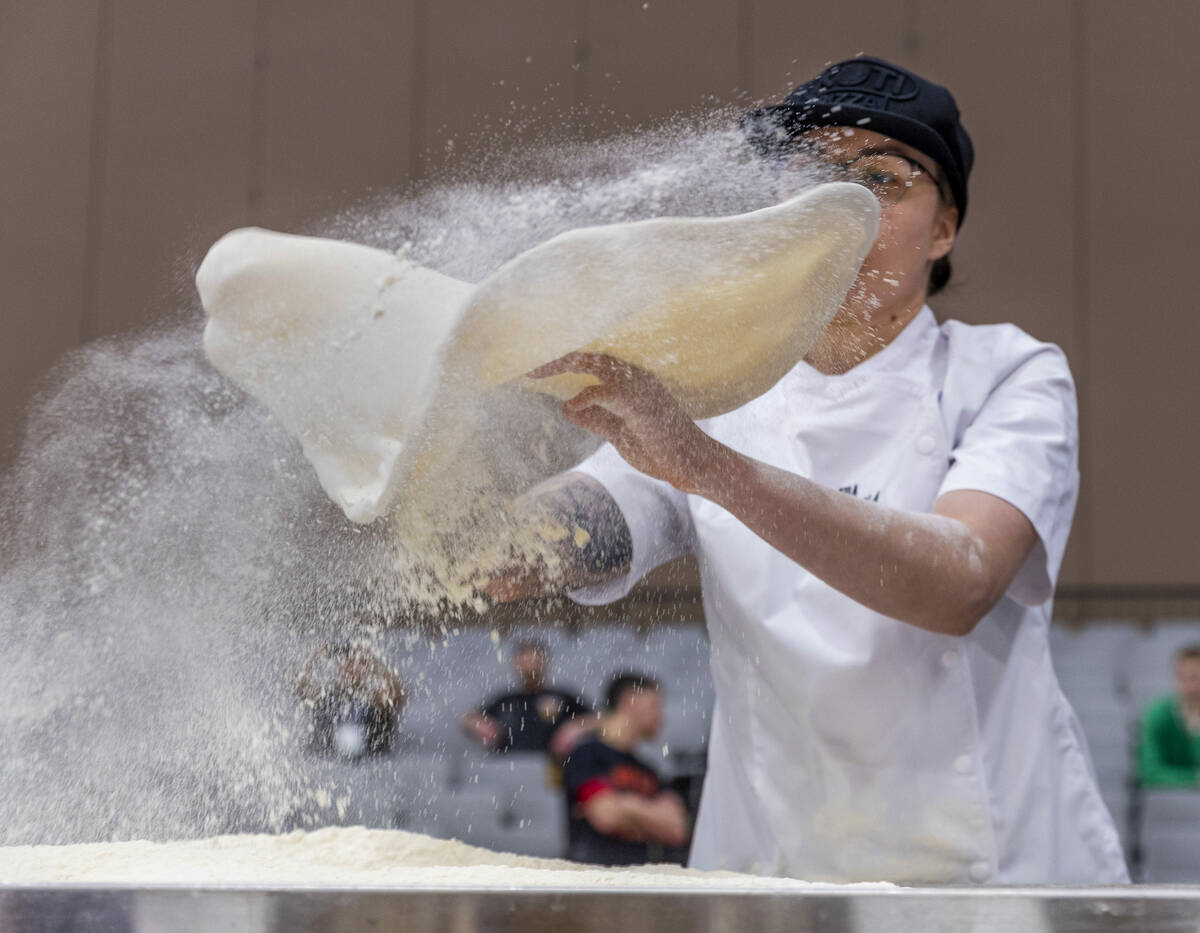Katie Korkko with Koti Pizza tosses her large pie dough during the Pizza Triathlon at the Inter ...