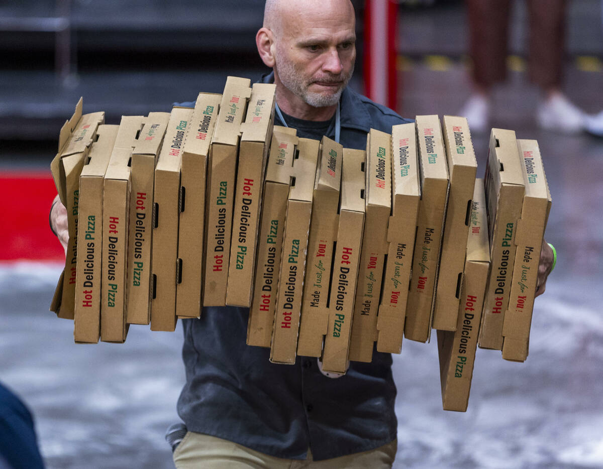 Folded boxes are taken off the floor during the Pizza Triathlon at the International Pizza Expo ...