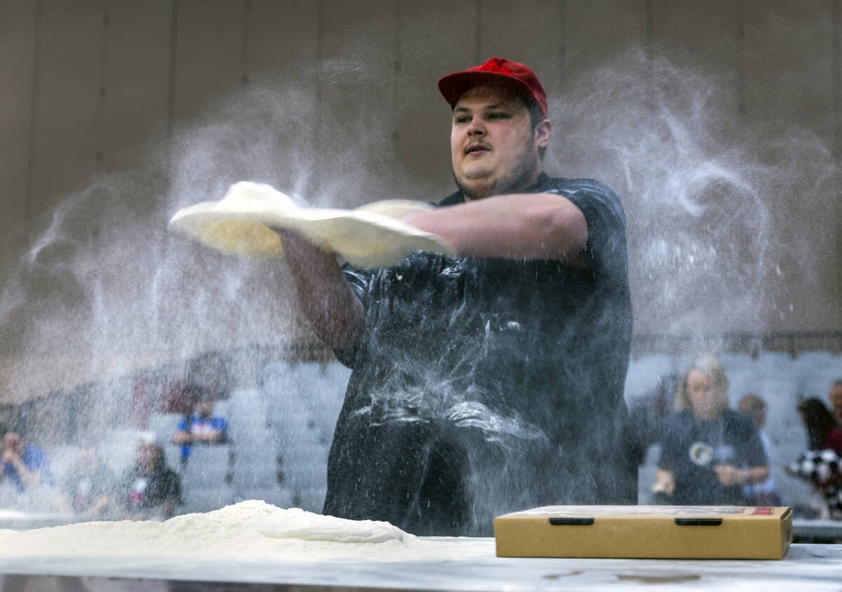 Competitor Perry Bogacz with the Caliente Pizza & Draft House tosses his medium pie crust d ...