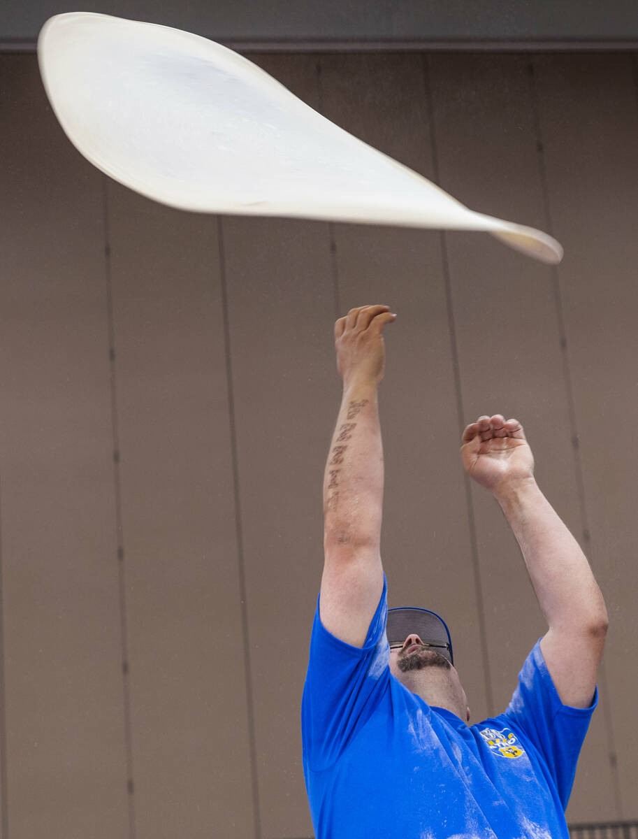 Competitor David Whisker with B.C. Pizza tosses his large pie crust during the Pizza Triathlon ...