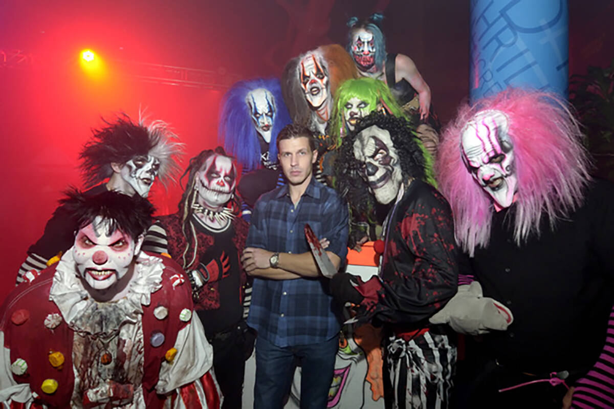 Jason Egan, owner of Fright Dome, center, is shown with some of the clowns at the haunted house ...