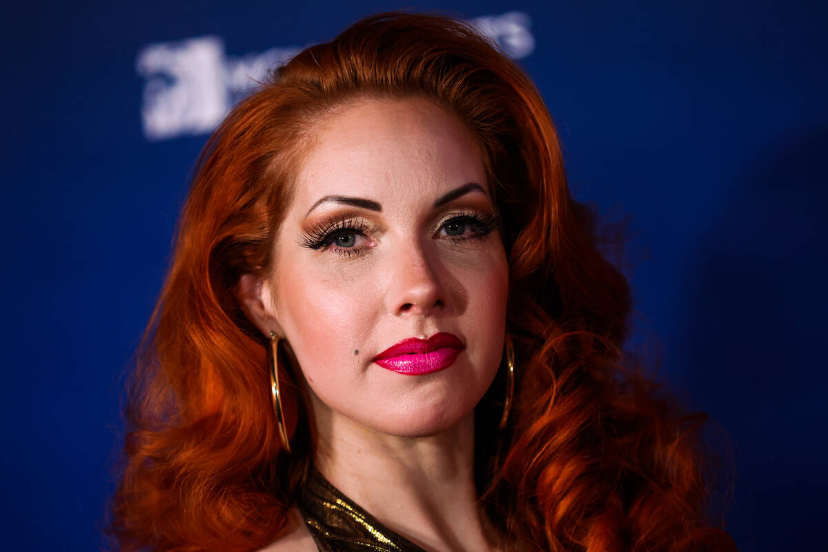 Banbury Cross, a burlesque artist, poses on the blue carpet at the One Night for One Drop event ...