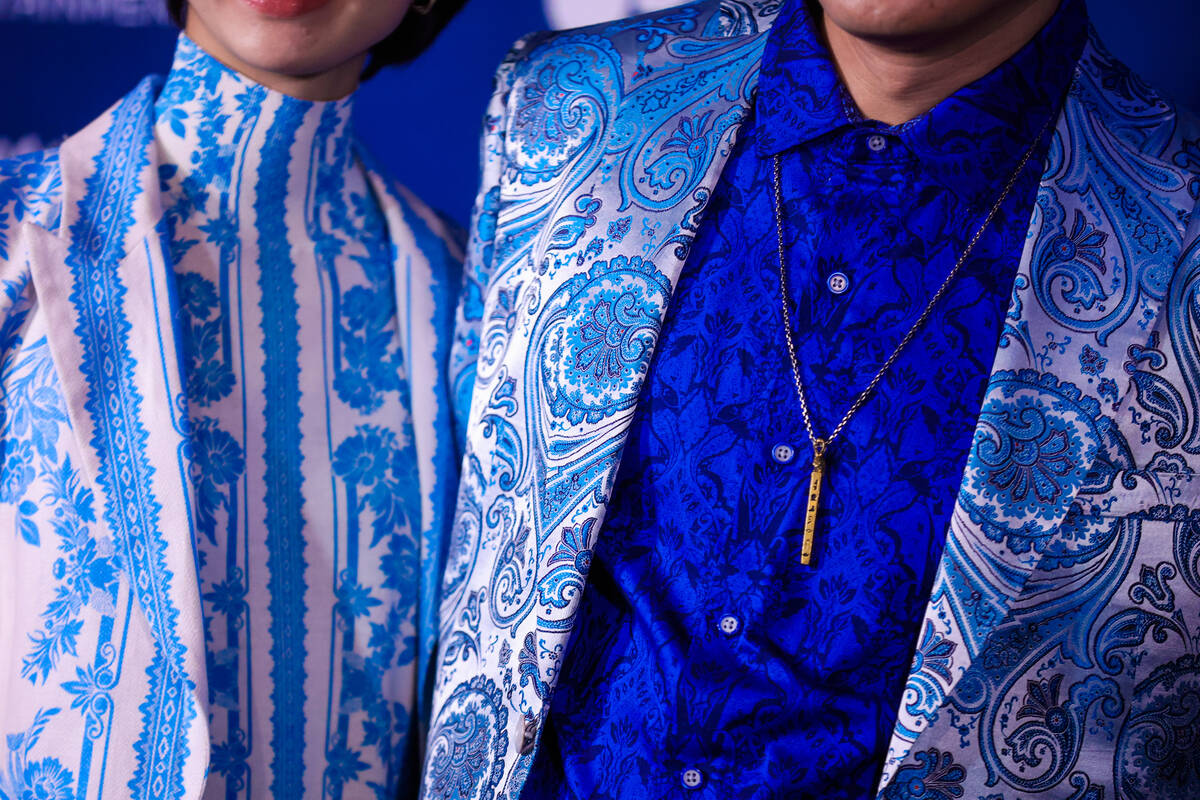 Poseidon Ho, a poker player, right, poses with his wife Molly on the blue carpet at the One Nig ...