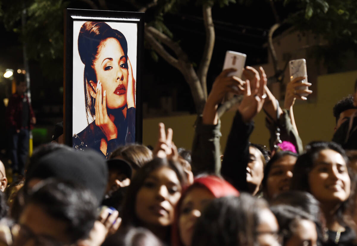 FILE – A portrait of the late singer Selena Quintanilla is seen in the crowd following a ...