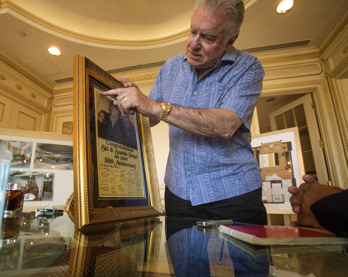 David Siegel, president and CEO of Westgate Resorts, shows a newspaper clipping from a Las Vega ...