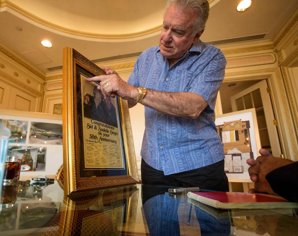 David Siegel, president and CEO of Westgate Resorts, shows a newspaper clipping from a Las Vega ...