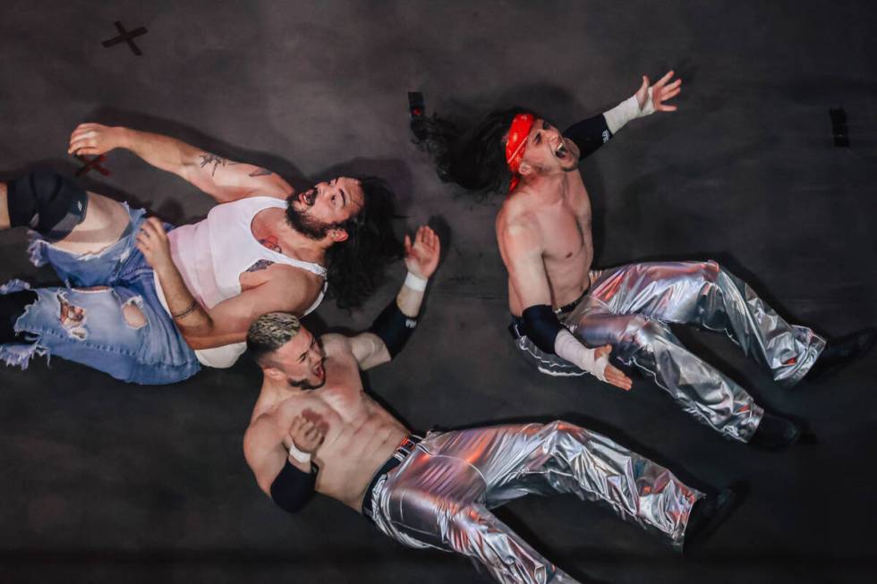 Wrestlers react after a body slam during a match late at night at Neonopolis Thursday, April 17 ...