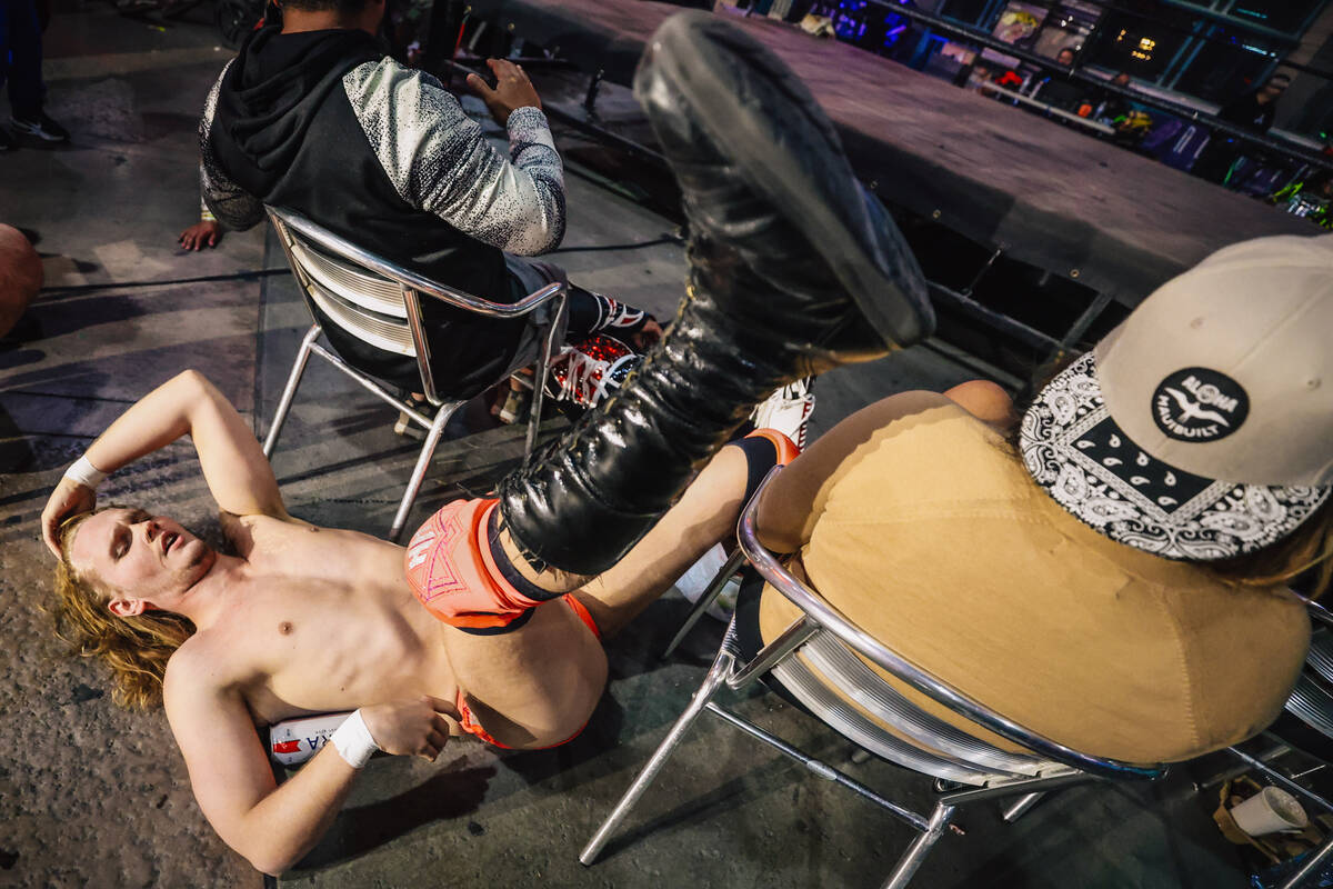 A wrestler lands in the crowd during a match at Neonopolis Thursday, April 17, 2025, in Las Veg ...