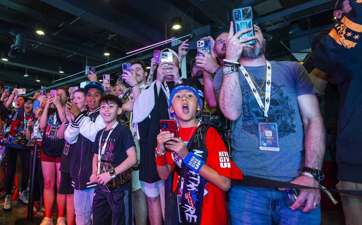 Fans sense the moment is at hand as they await the entrance of WWE champion Cody Rhodes during ...