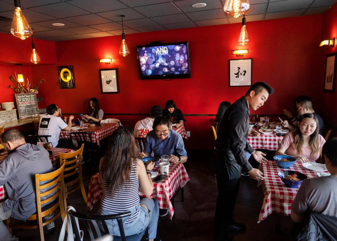 Checkered tablecloths are a nod to the Italian influence at Trattoria Nakamura-Ya, the calligra ...