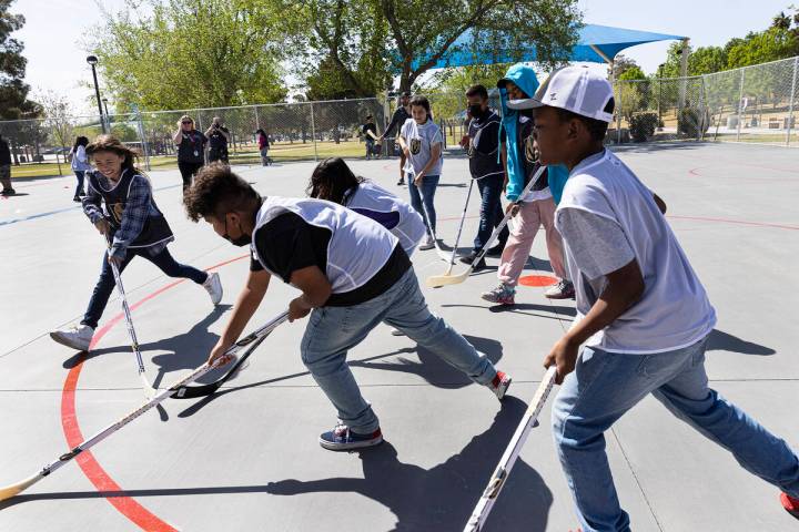 Children play on the Vegas Golden Kight’s Ball Hockey Rink at Lorenzi Park after the ribb ...