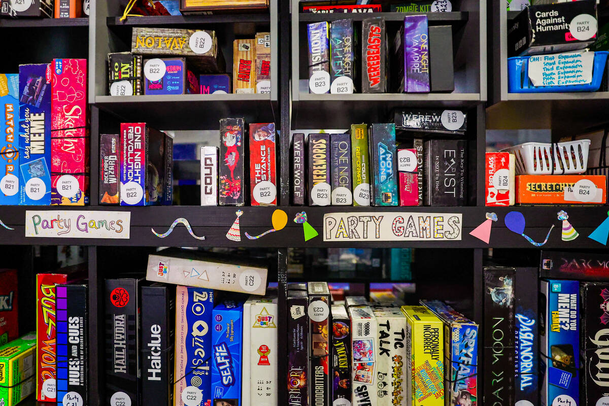 Games for people to play sit on shelves at Meeplevile Board Game Cafe on Thursday, March 20, 20 ...