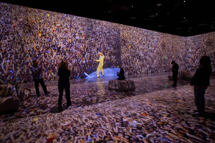 An image of David Bowie is displayed as people take in a preview of “Rolling Stone Prese ...
