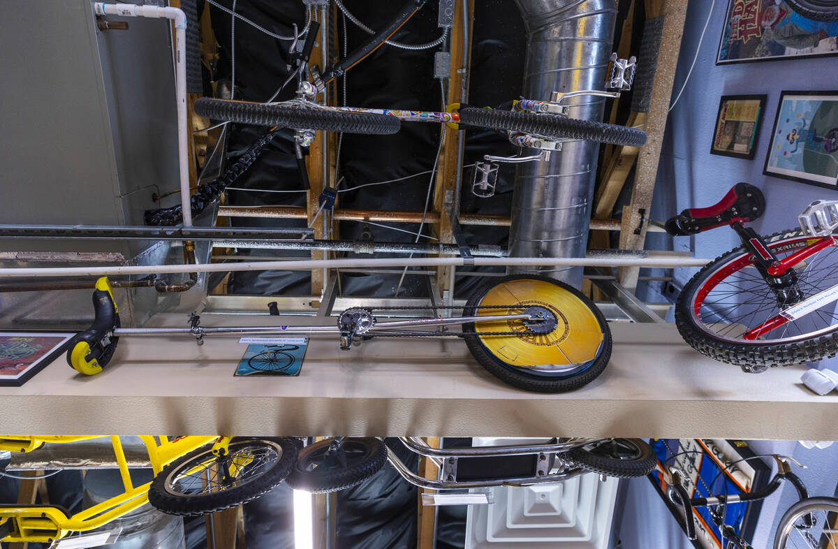 Unicycles hang from the rafters in the Vault Bicycle Shop which has a “Walk down memory ...